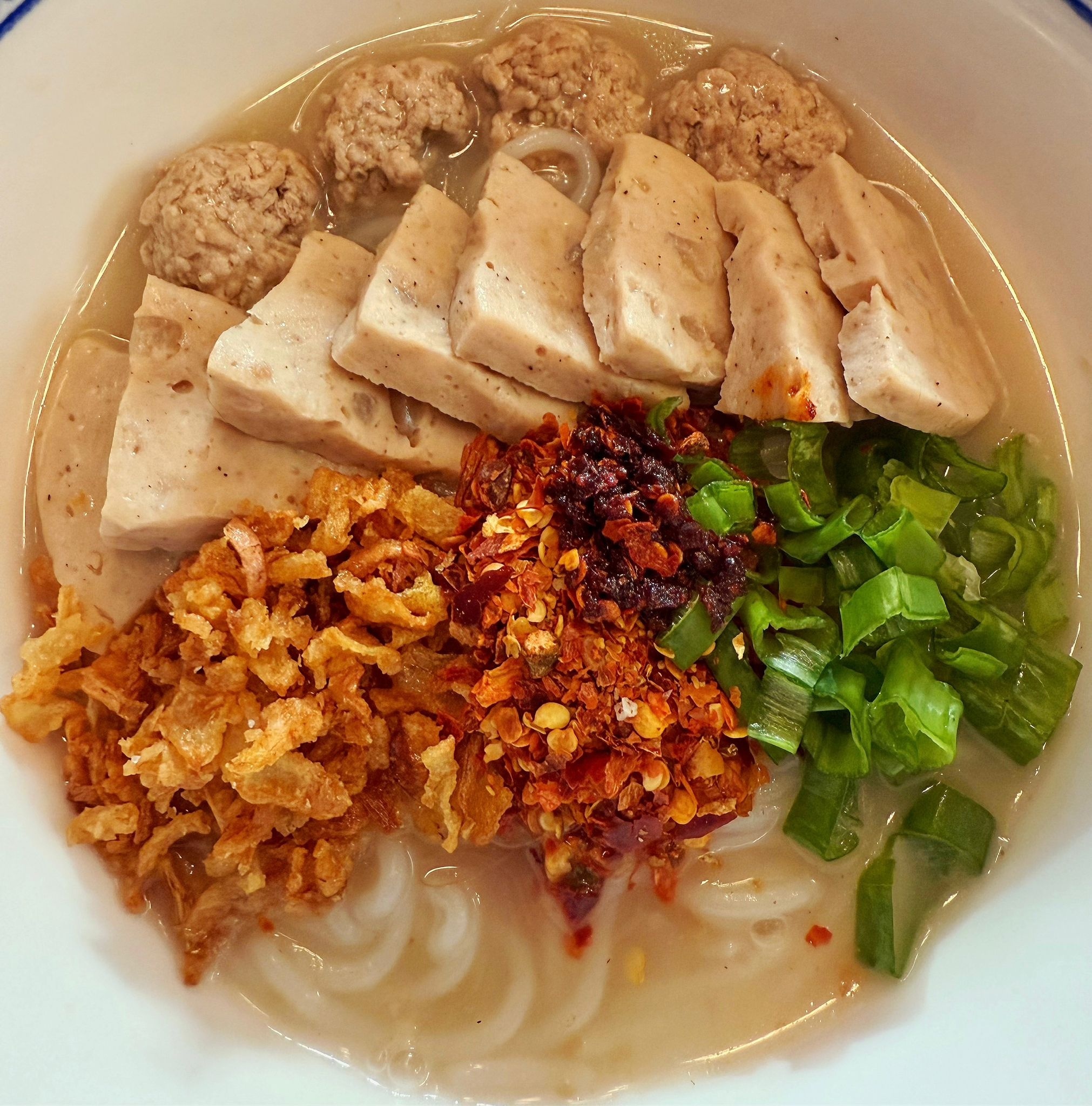 A close view of the same Thai soup showing herbs, broth, and seafood on Koh Samet.